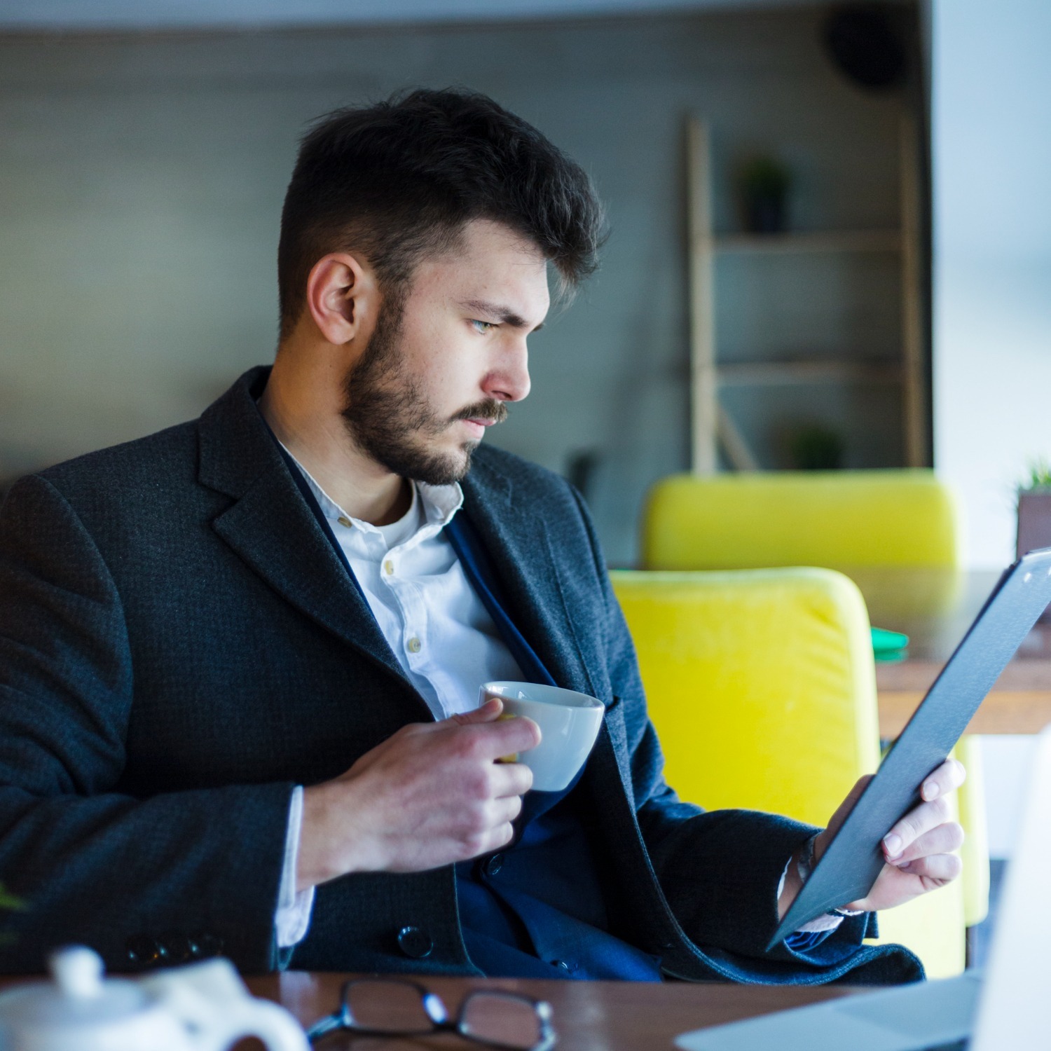 Man looking at tablet while doing e-learning on prohibition of insider trading