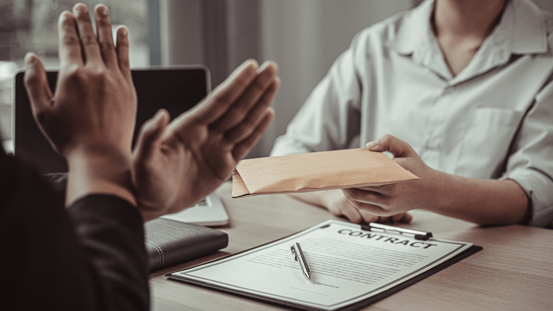 this image shows a person giving bribe and other person refusing it.