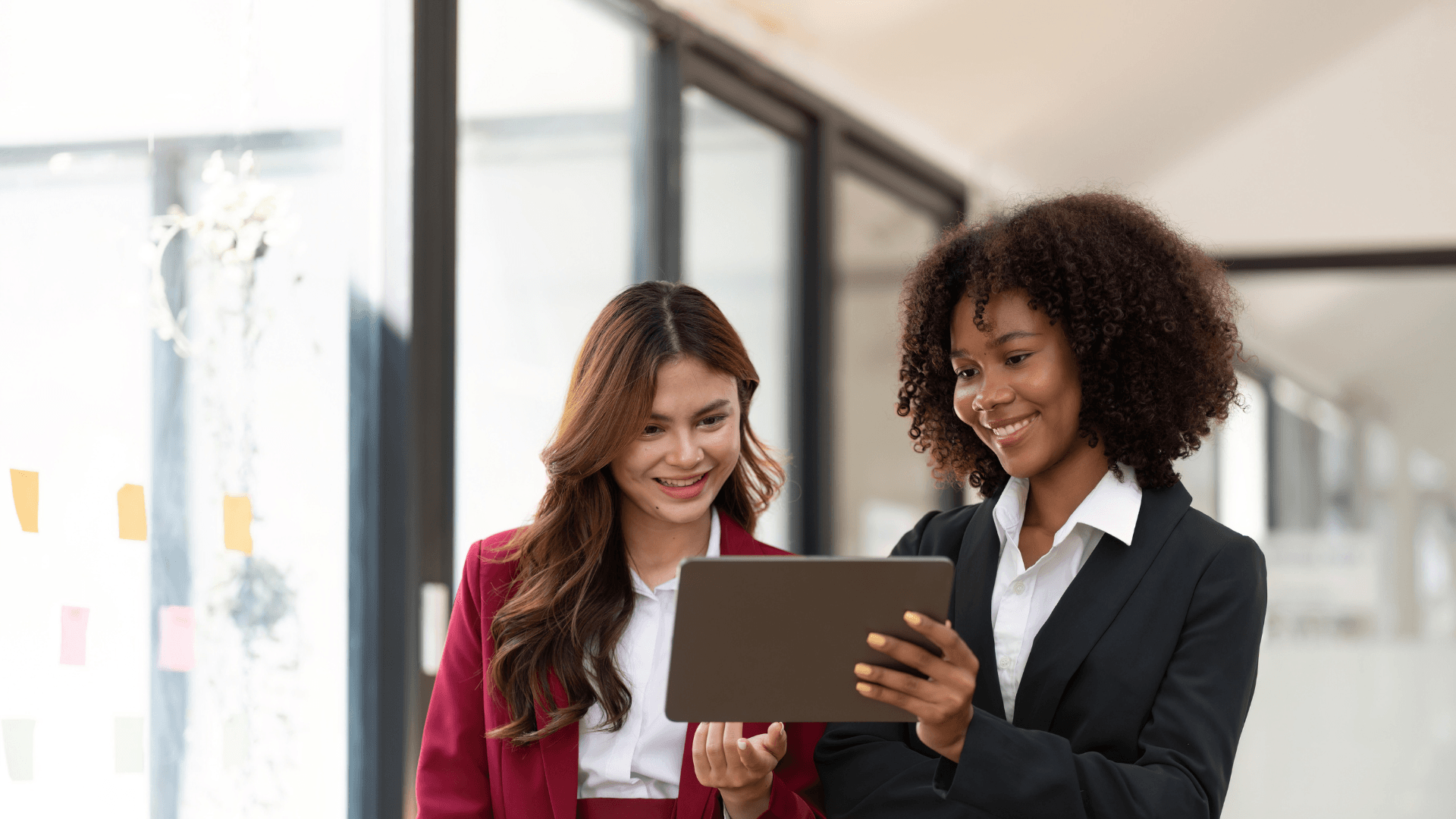 this image shows two AMC employees holding tab and going through e-learning